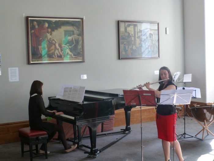 Image of Liz performing on flute with piano accompaniment